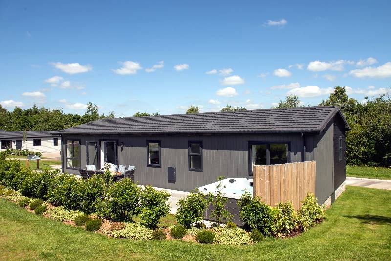 Click here for more about Juniper Lodge, 28 Roadford Lake Lodges